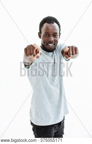 Confident Young Man In A White T-shirt Points At You