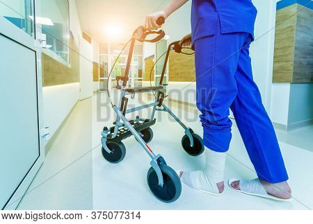 Patient On Rollator With Hand Brakes Moving In Hospital