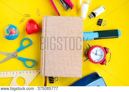 School Supplies And Mockup Daybook On Yellow Background, Top View. Back To School Concept
