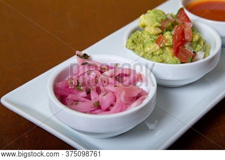 Mexican-style Sauces For Dipe. Guacamole And Purple Onion