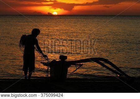Silhouette Of A Fishing Boat At Dusk On The North Coast Of The Island Of Java