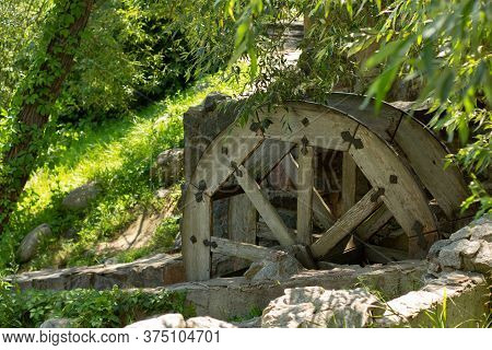 Old Wooden Water Pumping Wheel On River