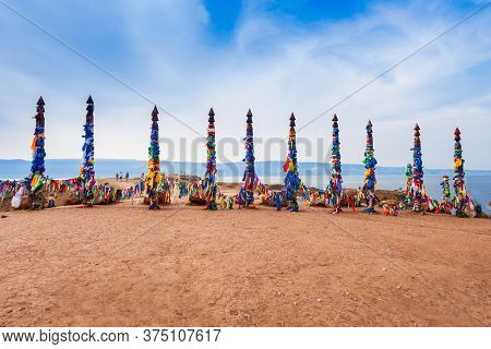 Serge With Colorful Strips Near Shaman Rock On Olkhon Island. Serge Is A Ritual Pillars And Trees Bu