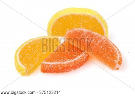Composition Of Marmalade Candy In Shape Of Citrus Fruits Wedges. Yellow And Orange Jelly Sweet Candi