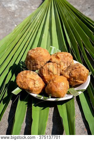 Palm Jaggery In A Plate Isolated On A Palm Leaf In Vertical Orientation