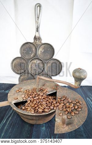 Old Rusty Antique Vintage Wellused Coffee Roaster And In The Background An Mini Pancake Pan