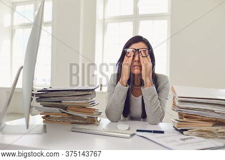 A Lot Of Work In The Office. Tired Busy Businesswoman Is Working With Computer.