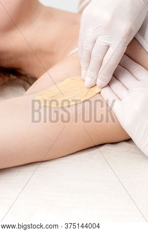Hand Of Cosmetologist Applying Wax Paste On Armpit. Depilation Or Epilation Female Armpit With Liqui