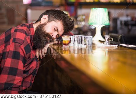 Man With Tired Face Sit Alone At Bar Counter