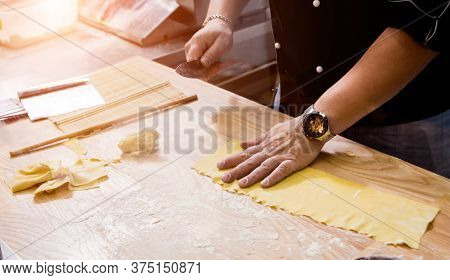 Chef Rolling Dough With A Pasta Machine. Pasta Maker Machine.