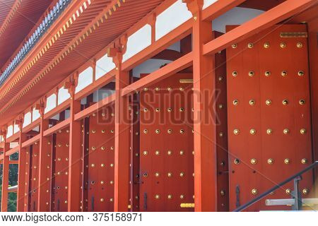 Tall red pillars and doors of historic Yakushi-ji temple in Nara, Japan.