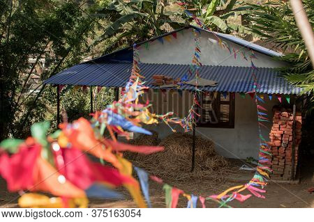 Buddhist Praying Flags Attatched To A Small House In A Nepalese Village, Annapurna Circuit