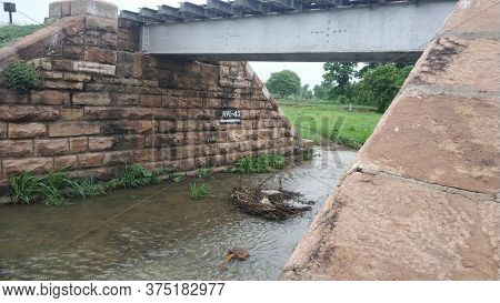 Railway Bridge Made Of Stones With Stream Water
