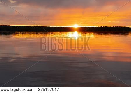 Water Surface. Sunset Sky Background. Gold Sunset Sky With Evening Sky Clouds Over The Lake. Small W