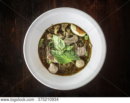 Thai Oriental Noodle, Nooddle In Blood Seasoning Soup With Meat Ball And Pork And Sweet Basil Leaf
