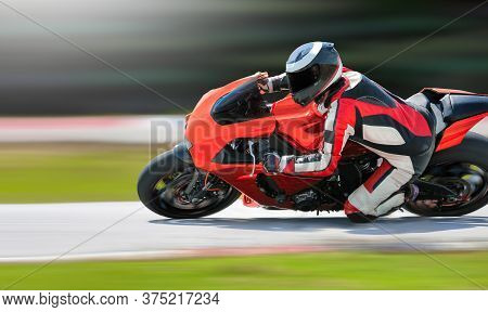 Motorcycle Leaning Into A Fast Corner On Race Track