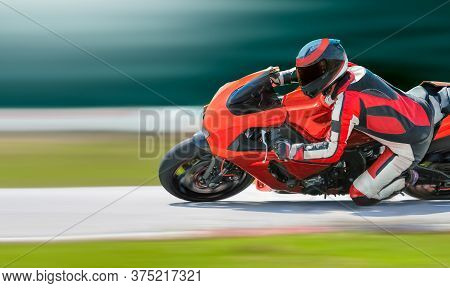 Motorcycle Leaning Into A Fast Corner On Race Track