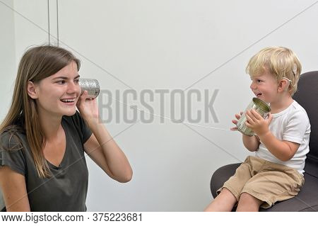 A Boy With Cochlear Implants Playing Tin Can Phone