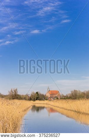 Little River Leading To The Small Town Of Holwierde In Groningen, Netherlands