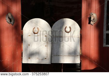 Wooden Old Door Of West Saloon, Cowboy Gate Style On Sunshine.