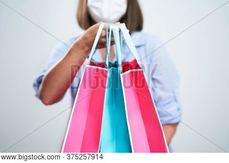 Attractive woman wearing protective mask isolated over white background