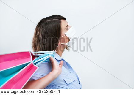 Attractive woman wearing protective mask isolated over white background