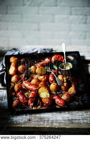 Sausage And Potato Traybake..style Rustic. Selective Focus