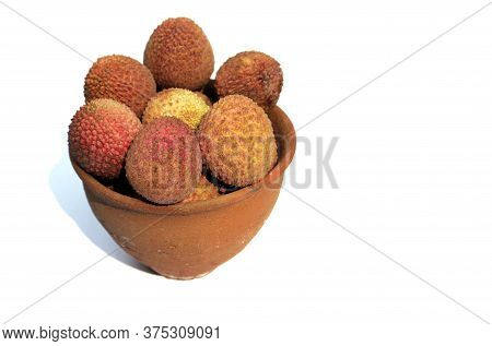 Stack Of Organic Lychee Or Lichi Fruits In A Clay Bowl Isolated On White Background With Copy Space 