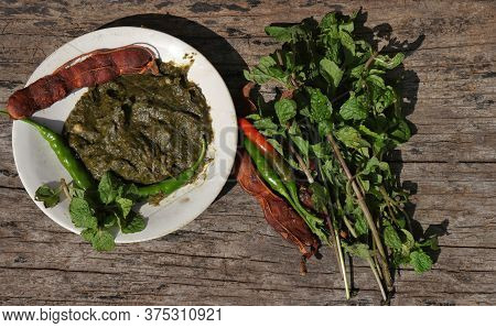Pudina Chutney Or Field Mint Leaves Paste In A Plate With Raw Ingredients On Wooden Background