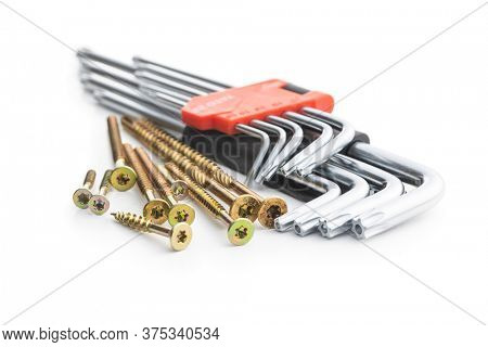 Torx screwdrivers and metal screws isolated on white background.