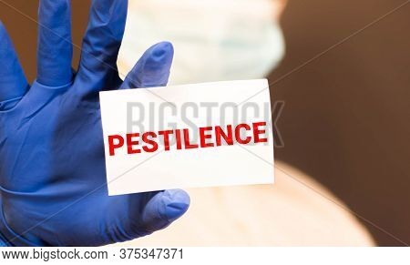 Scientist In Safety Suit Pointing To Word Caution