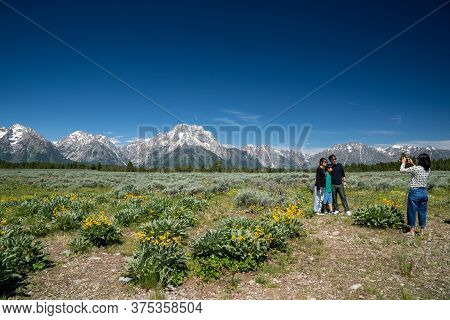 Grand Teton National Park, Wyoming - June 26, 2020: Tourist Family Poses For Photos At A Scenic Pull