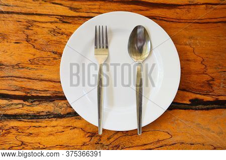 Empty Plate With Spoon Fork On Food Table Wooden Background / Empty Dinner Plate Dish , Top View