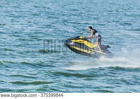 Voronezh, Russia - 23.08.2019 - Man On Water Scooter. Splashes And Drops Around. Summer Vacation On 