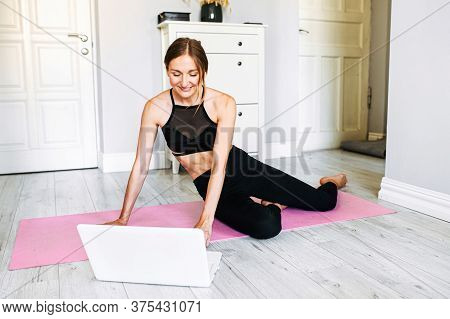 An Online Attractive Female Coach Is Talking To A Client Using A Webcamera Before Online Workout. Sh
