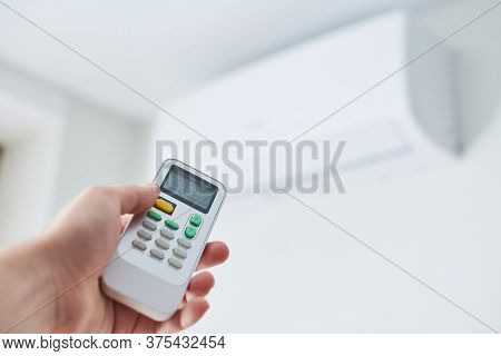 Remote Control For Air Conditioner In Hand. Room Condition Remote Control. Air Temperature Switch Fo