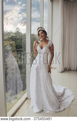 Beautiful Bride In Her Wedding Dress Posing For Photos.