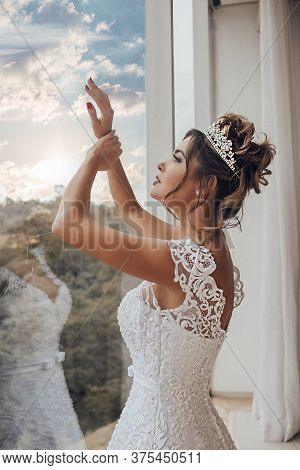 Beautiful Bride In Her Wedding Dress Posing For Photos.