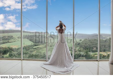 Beautiful Bride In Her Wedding Dress Posing For Photos.