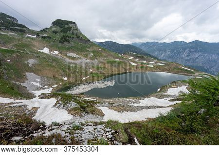 Lake In The Austrian Alps With Last Snow. Augstsee. Loser. Austria