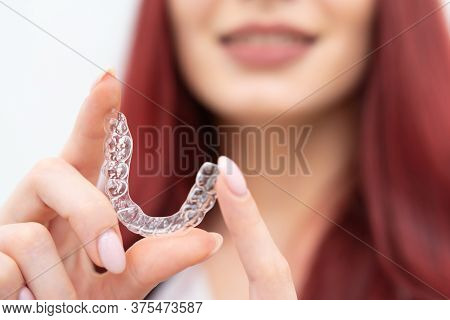 Girl With A Beautiful Smile Shows A Transparent Mouth Guard