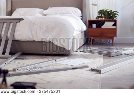 Instructions And Components For Self Assembly Baby Cot On Bedroom Floor