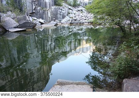 Small Natural Lake Inside A Marble Quarry In Mountain In Apuan Alps