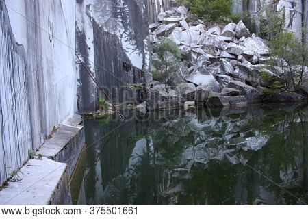 Small Natural Lake Inside A Marble Quarry In Mountain In Apuan Alps