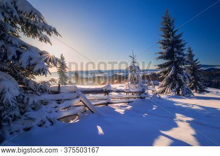 Snowy Winter Scene In The Sunrise Near A Village In Romania