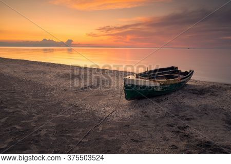 Beautiful Morning On A Beach With A Fishing Boat Tied To A Rope On The Black Sea Coast In Romania At