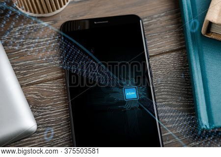 Close Up On A Phone That Includes E-sim. Data Streams Into The Gadget
