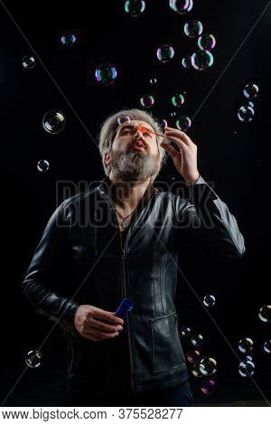 Soap Bubbles. Man Play With Bubbles. Man Blowing Bubbles. Bearded Man Blowing Soap Bubbles. Happines