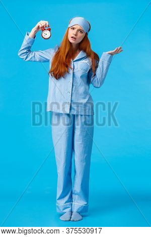 Why Didnt You Set Alarm. Confused And Unsure Upset Attractive Redhead Woman In Pyjama And Sleep Mask