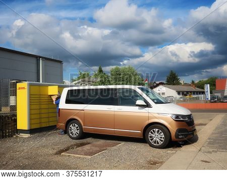 Vw Van By Dhl Packstation, Open Box, Man Taking Package Out. Konz, Germany - June 27, 2020